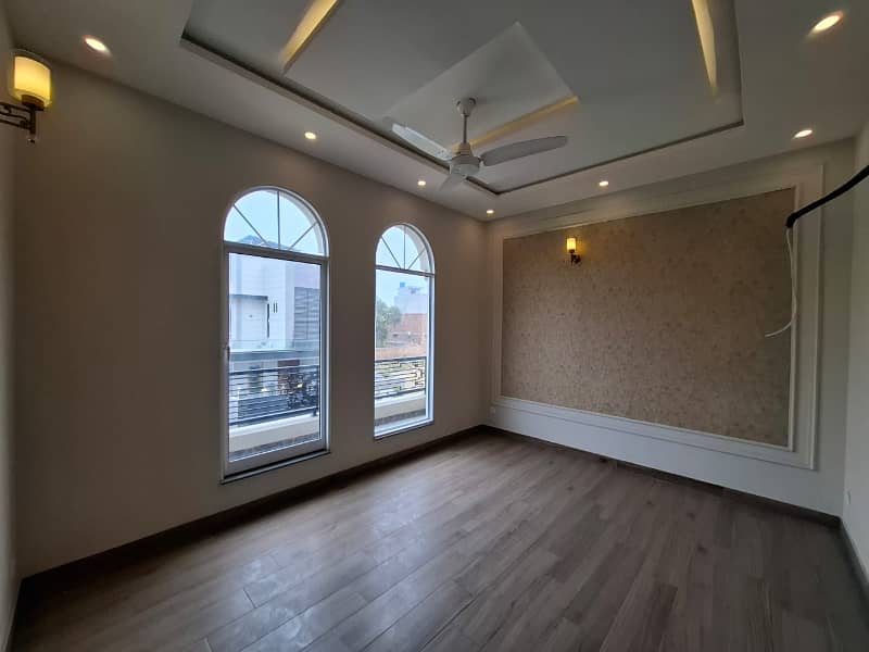 Elegant Triple-Story 10 Marla Home in DHA EME Block D with Distinct Spanish Elevation, Functional Basement with Drawing Room & Study, Separate Side Stair Access for Privacy, and High-Quality Construction by Build Force 30