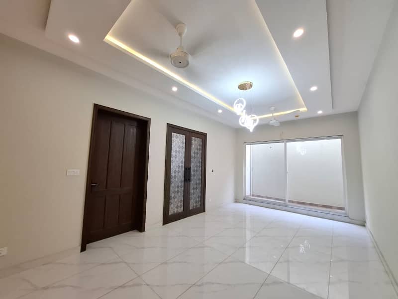 Elegant Triple-Story 10 Marla Home in DHA EME Block D with Distinct Spanish Elevation, Functional Basement with Drawing Room & Study, Separate Side Stair Access for Privacy, and High-Quality Construction by Build Force 34