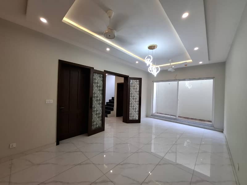 Elegant Triple-Story 10 Marla Home in DHA EME Block D with Distinct Spanish Elevation, Functional Basement with Drawing Room & Study, Separate Side Stair Access for Privacy, and High-Quality Construction by Build Force 36