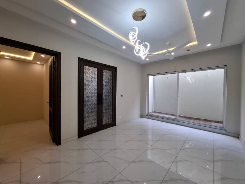 Elegant Triple-Story 10 Marla Home in DHA EME Block D with Distinct Spanish Elevation, Functional Basement with Drawing Room & Study, Separate Side Stair Access for Privacy, and High-Quality Construction by Build Force 37