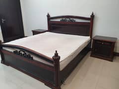 Wooden bed with two side tables