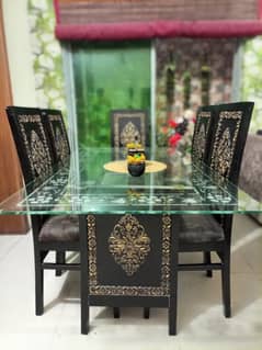 6 seater wooden dining table with glass top in good condition