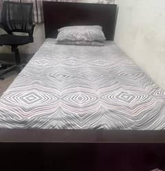 wooden bed with dark coffee colour