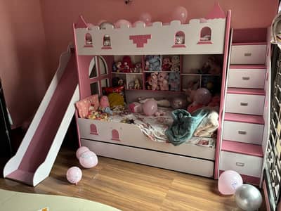 Girls triple mattress bed with cupboard.