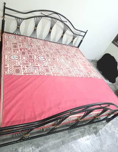 Strong iron bed with dressing table available for sale.