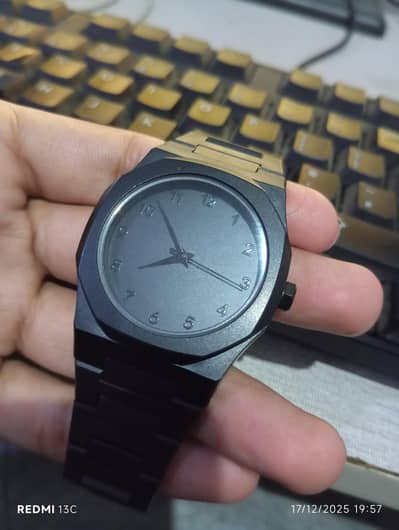 Black aura watch with wrist lock.