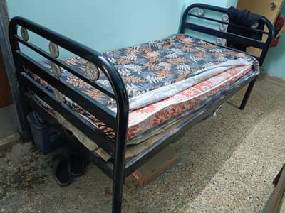 single iron bed with mattress