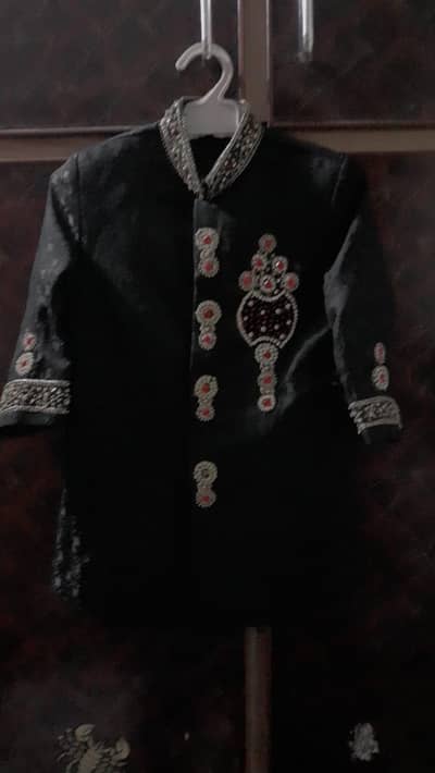 Black sherwani with red safa pagri