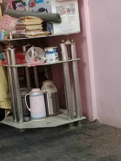 glass table with iron  supporting pillars