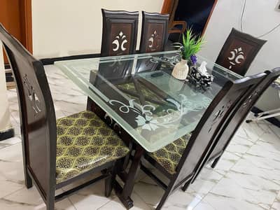 6 seater glass dining table with wooden base and chairs