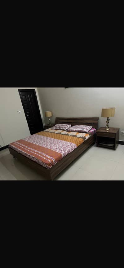 Wooden king size bed.  Bedside Tables & Dresser — Stylish & Durable