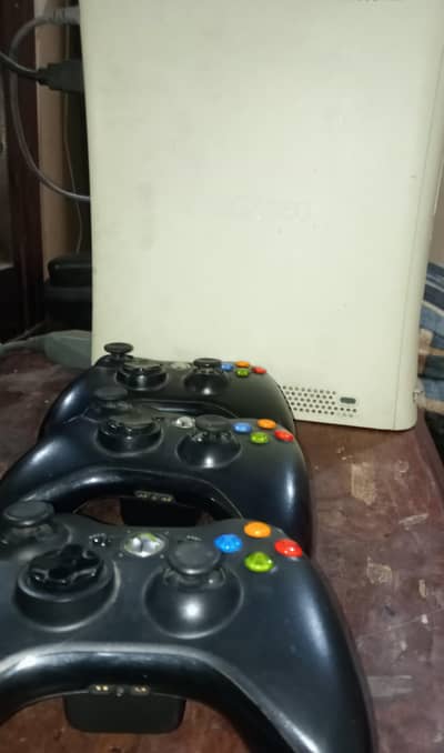 XBOX 360 with 3 original wireless controllers .