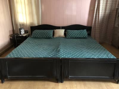 Wooden 2 single beds in black colour