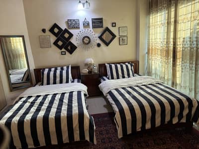 Two single wooden beds with side table,mattresses included