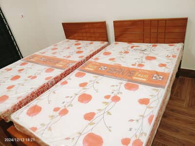 2 wooden single beds