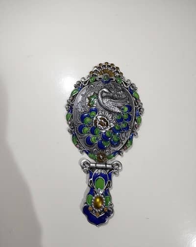 small traditional mirrror with a comb