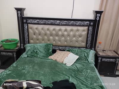 wooden bed with side tables and dressing