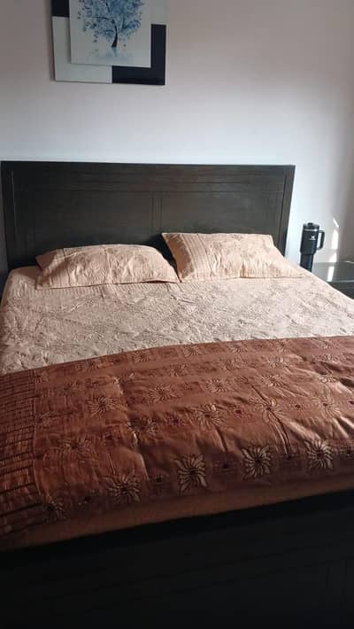 Queen size wooden bed with spring mattress