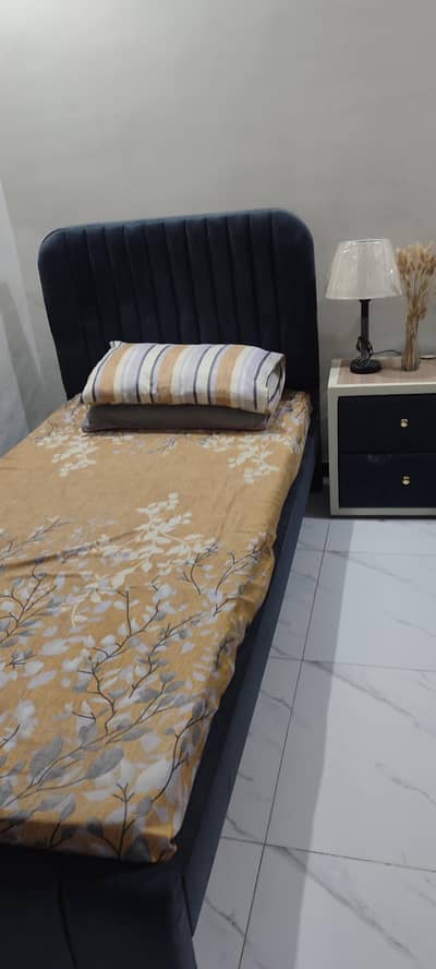 2 single beds 1 side table without mattresses