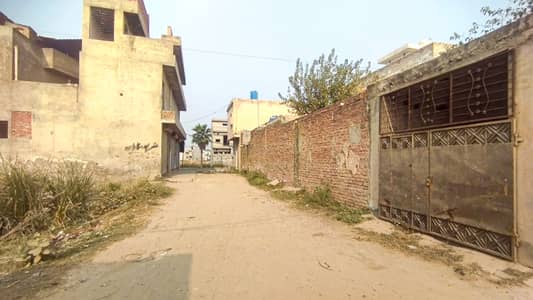 1 kanal 3 side road commercial plot with three shops and apartment already rented