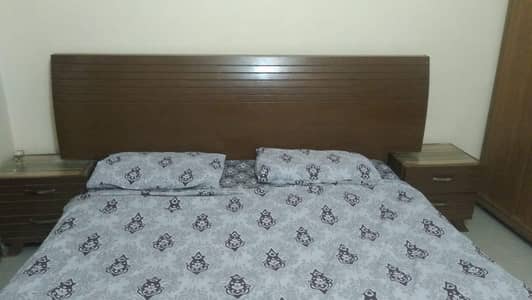 wooden bed set with side tables in good condition
