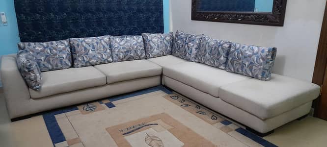 L shaped off white sofa
