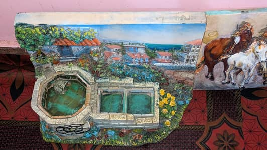 decorative water fountain with a miniature village design