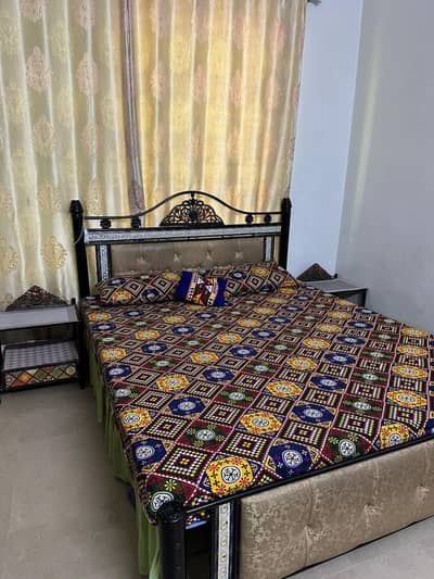 iron bed with side table