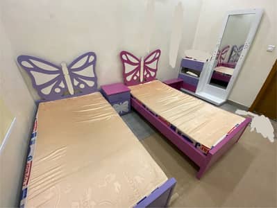 Two single girls' beds.