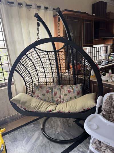 Large swing with metal stand and cushions