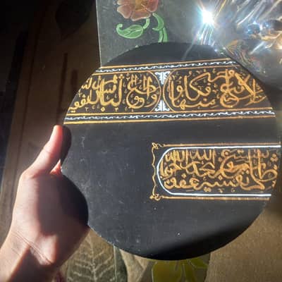resin covered Arabic calligraphy painting on a wooden piece