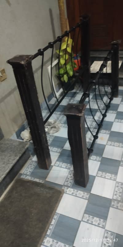 Wooden pillars, iron bed. size 5.2 by 6.2 approx