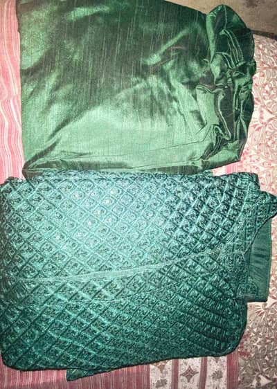 This is an stitched emerald green velvet embroidered fabric set.