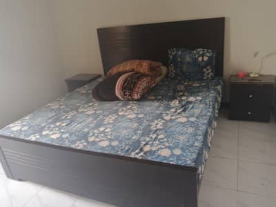 wooden bed with side tables