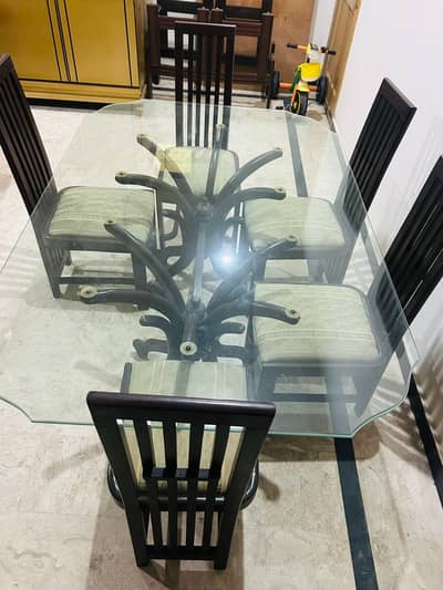 solid wooden dining table with glass top