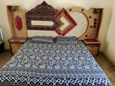 wooden bed with side table