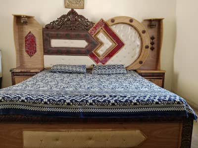 wooden bed with side table