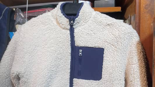 Cozy White fleece jacket with blue pocket for 9 year old kid