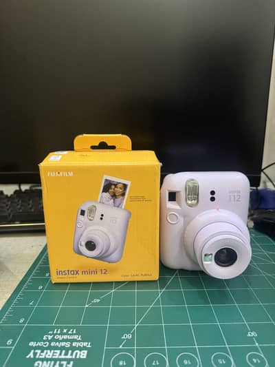 Instax mini 12 instant camera in lilac purple color with box