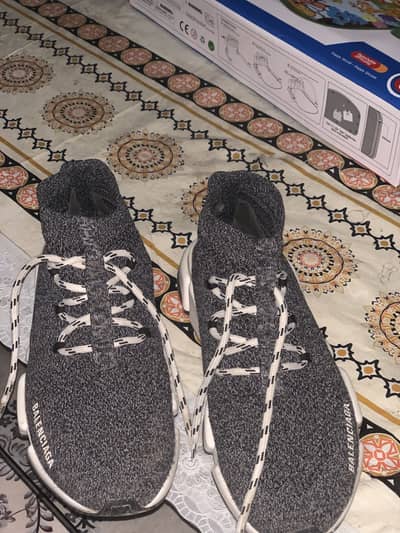 This is a Balenciaga Speed Lace-Up Trainer in a grey/black knit