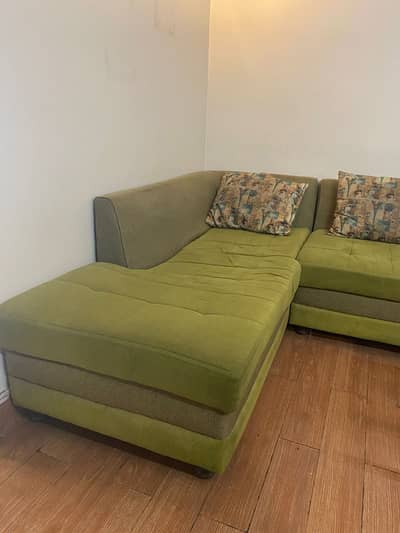 L-Shaped olive green sofa