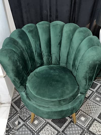Green Velvet Lounge Chair with  stunning artistic table lamp placed