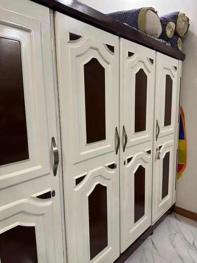 Double bed with 2 side drawers and 4 door cupboard