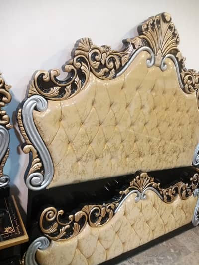 Royal style curved wooden bed with a tufted headboard and footboard