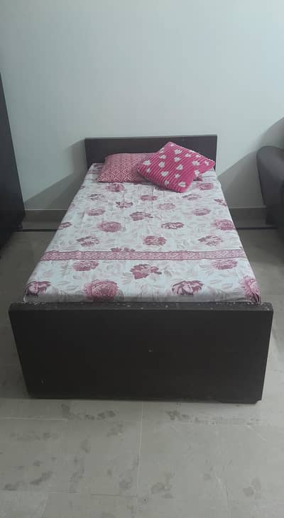 Wooden single bed.