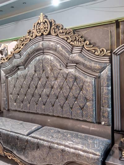 Bed set with a tufted headboard ,curved golden and silver accents