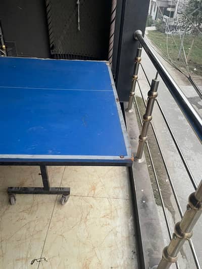 a Table Tennis in average condition with side hooks and center net