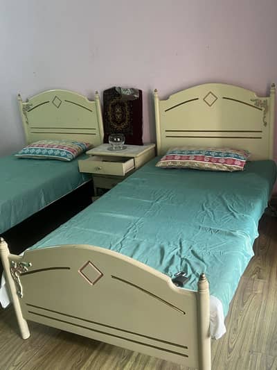 2 wooden beds with mattresses
