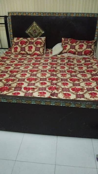 double bed with 2 side tables and a dressing