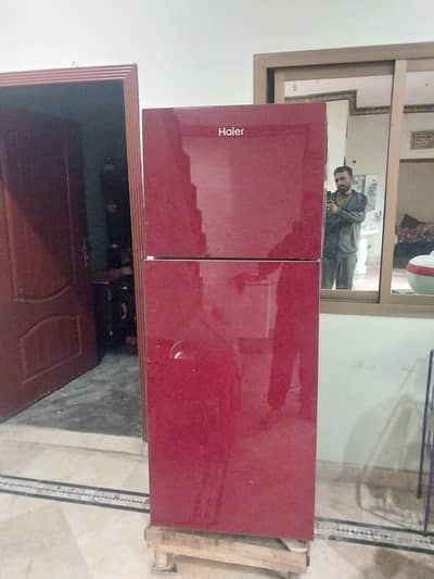 Haier refrigerator medium size red colur like new construction in home